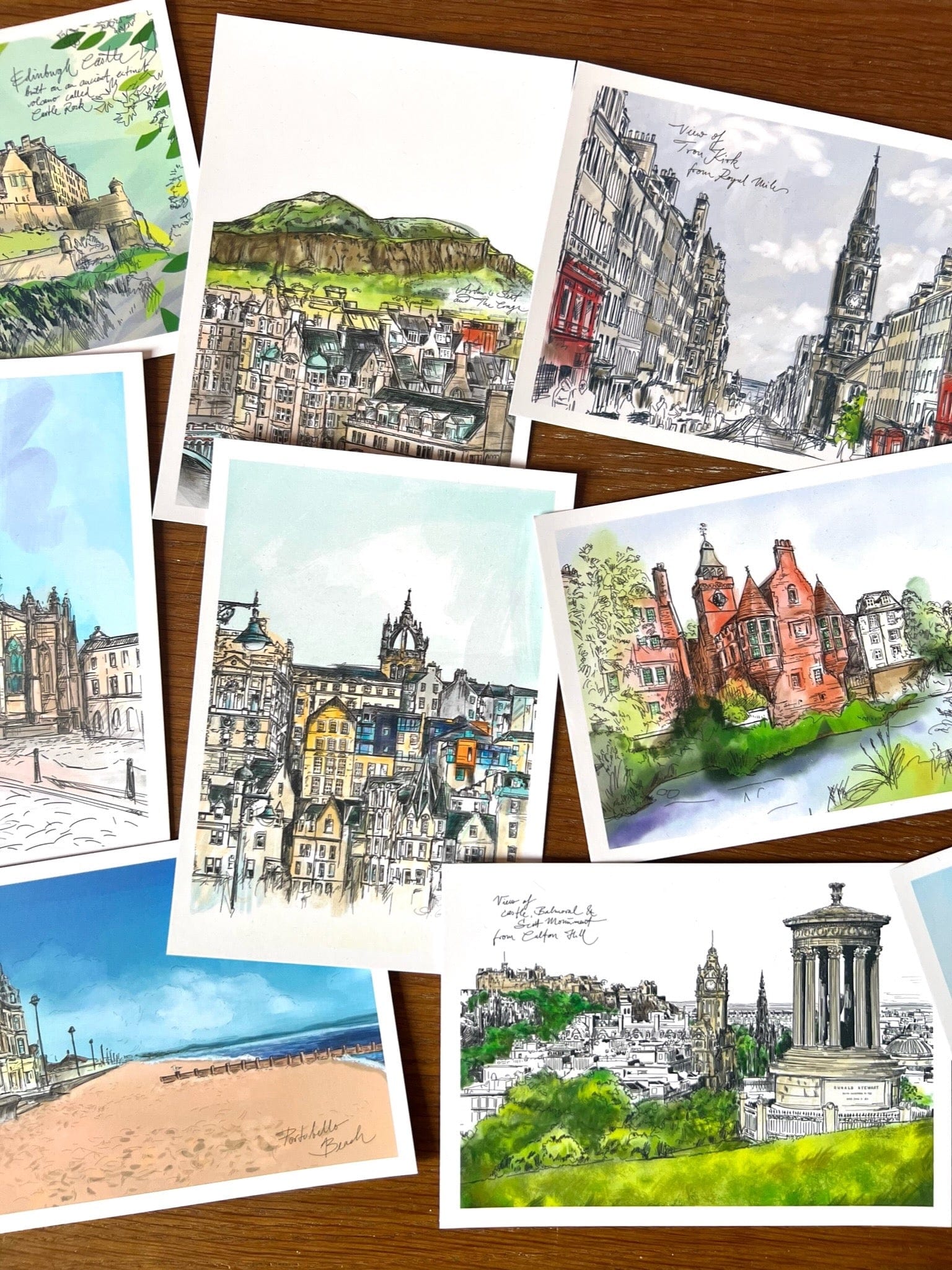 The Enchanting Edinburgh Mini Art Print Set by Essential Edinburgh features hand-drawn and watercolor postcard prints of iconic cityscapes and landmarks—a perfect souvenir or gift for any Edinburgh lover.