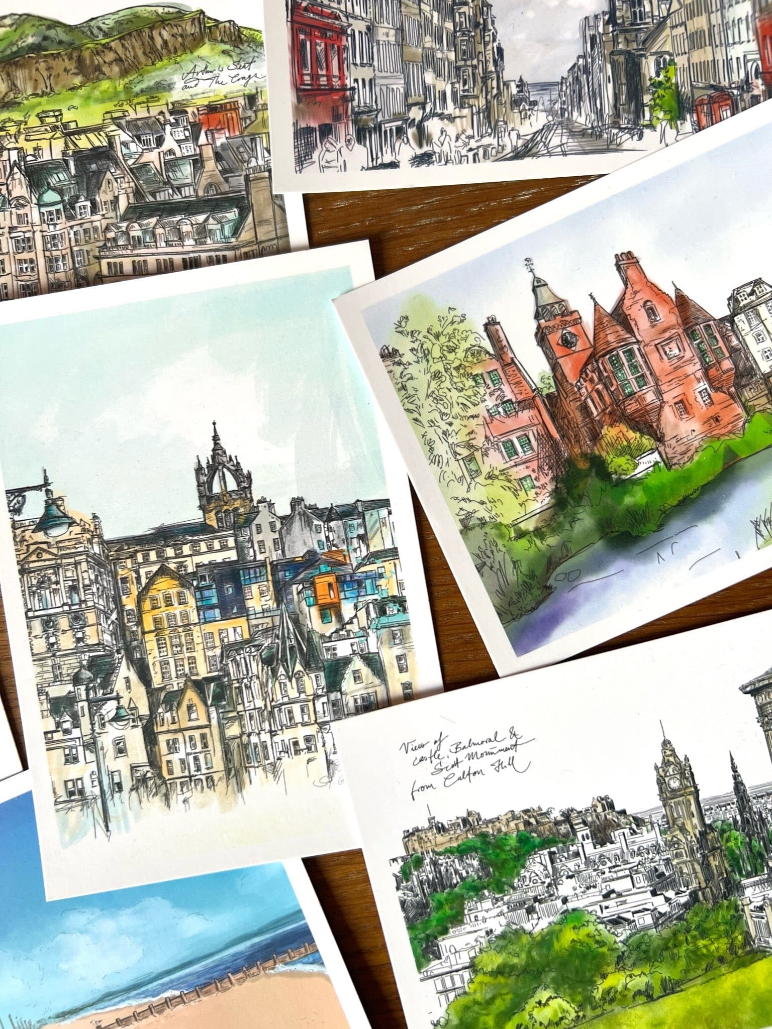 The Enchanting Edinburgh Mini Art Print Set by Essential Edinburgh features detailed watercolor and ink illustrations of iconic city landmarks, beautifully arranged and perfect as a unique souvenir or gift.