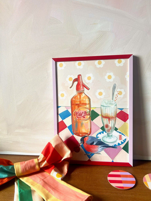 The Fat Finch Soda Giclée Art Print by Hôtel Dodo features a soda bottle, glass with spoon, bird on a patterned surface, colorful cloth, and two coasters—evoking retro ice cream float vibes.