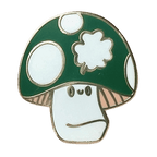 The Irish Luckshroom Pin by Pins by diedododa features a cartoon mushroom with a green cap, white spots, and a neutral-faced stem, all outlined in gold.