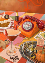 Certainly! The Harvest Club Giclée Art Print by Hôtel Dodo features an orange rotary phone, devil-horned cocktail, pumpkin, pie, lipstick, voodoo doll, tarot cards & jewelry on a colorful tiled table with autumn decor.
