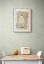 The Justice Matte Art Print by Tarot Cats—a collectible featuring a white cat in vintage tarot card style—hangs on a light green wall above a small table, adding charm and whimsy to your space.