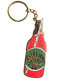 The Hôtel Dodo Aperitivo Keyring features a gold leopard and an enamel charm shaped like a red vintage soda bottle labeled "Aperitivo Leopardo," topped with a striped straw—a playful accessory for your bag.