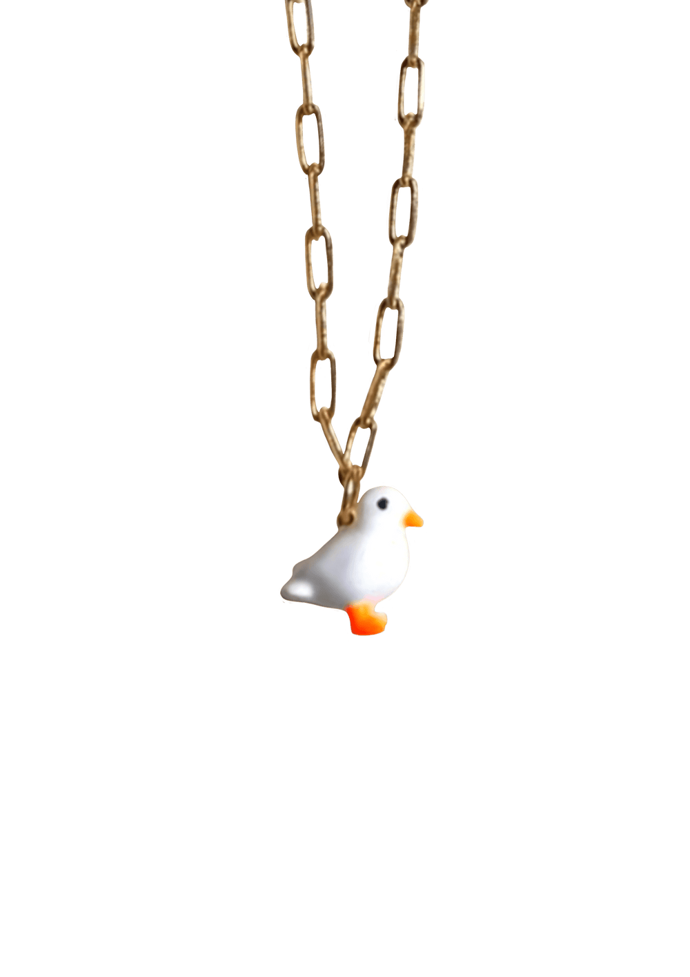 Discover the elegance of our Lucky Ducky Necklace by Necklaces, featuring a charming white bird pendant with an orange beak and feet on a gold small paperclip chain. This exquisite necklace offers an adjustable length for the perfect fit, ensuring both comfort and style.