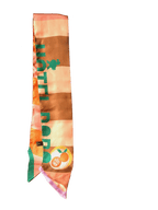 The Hotel Dodo Scarf by diedododa is a silk twill scarf in pink, orange, and brown stripes, featuring "HOTEL POP" in green and a circular peach "HOTEL POP" logo near the end.