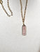 Magnifique Necklace with a medium paperclip chain and a scalloped pendant featuring a red and white design on a textured fabric surface by Necklaces.