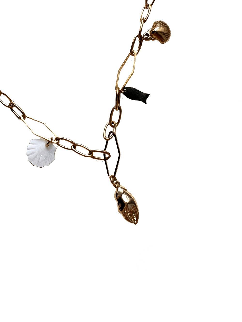 The Seaside Treasures Necklace by Necklaces features a gold chain adorned with seashell charms and a fish, secured with a reliable lobster clasp.