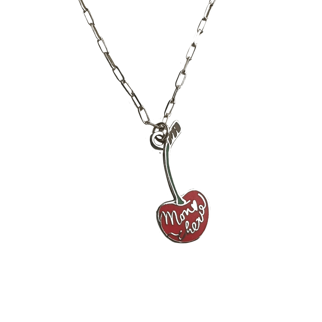 The Mon Chérie Necklace by Necklaces is a silver piece with a delicate cherry pendant on a stylish paperclip chain, elegantly inscribed with "Mon coeur" in cursive writing.