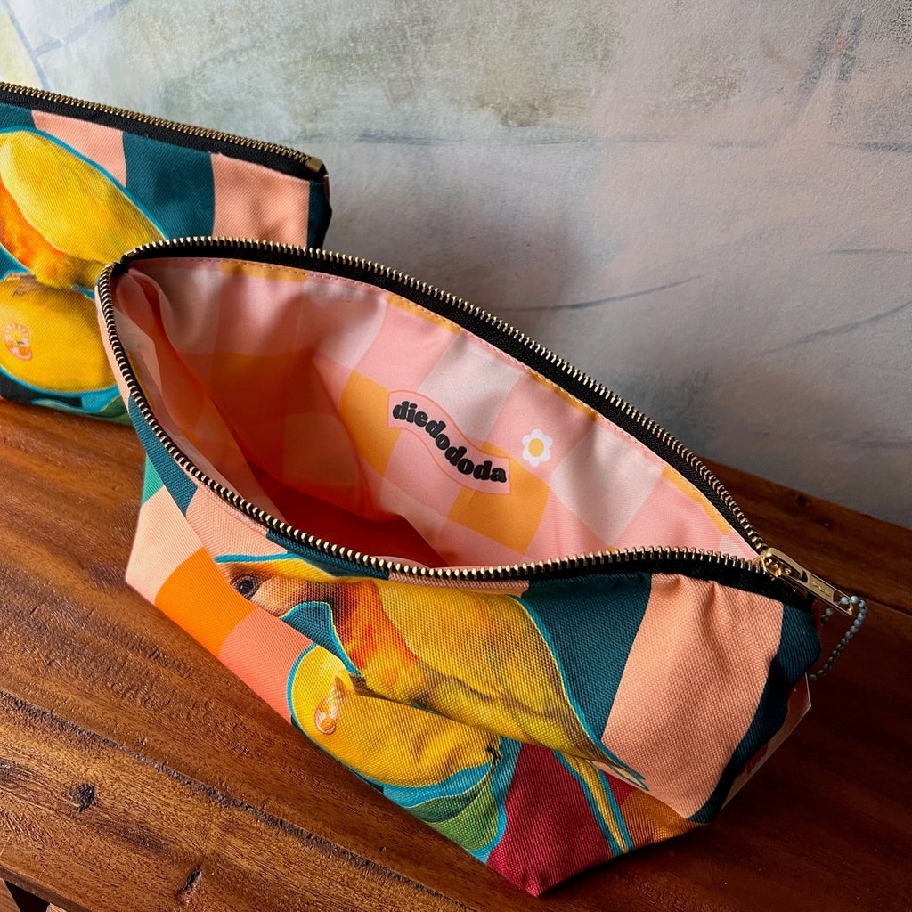 The Sticky Beaks Pouch by Sticky Beaks is a zippered tropical bird pouch with colorful prints, an open view of its peach and pink patterned interior, and a "Sticky Beaks" label—an ideal handmade accessory for your essentials.
