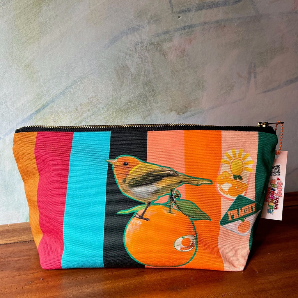 The Sticky Beaks Pouch by Sticky Beaks is a handmade cotton pouch with vertical colorful stripes, bird-on-orange illustration, and citrus and sun graphics. Crafted in the UK.