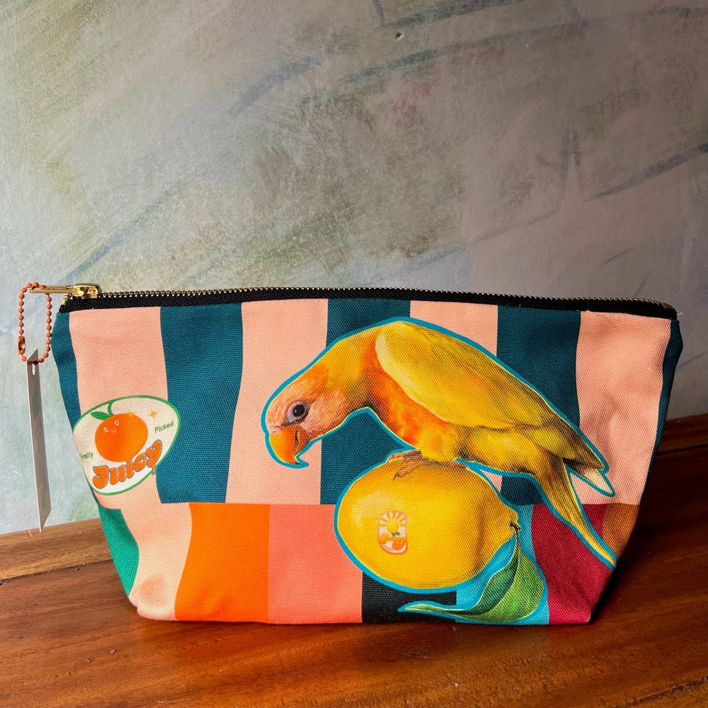 The Sticky Beaks Pouch by Sticky Beaks is a handmade UK cotton zip pouch, featuring bold stripes, a yellow parrot on citrus fruit, and a "Juicy" orange graphic—perfect for adding vibrancy to your market day.