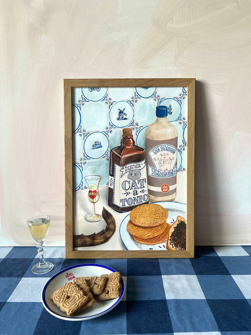 The Dutch Courage Giclée Art Print by Hôtel Dodo depicts vintage bottles, Dutch gin, stroopwafels, and cookies on a blue checkered table—capturing the charm of jenever and classic treats.