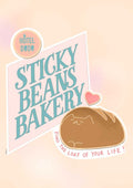 Matte art print titled “Sticky Beans Bakery Loaf Of Your Life” by International Pestsellers features a sign with the bakery name, Hotel Dodo logo, heart, and bread loaf. Below: “Find the loaf of your life!”.
