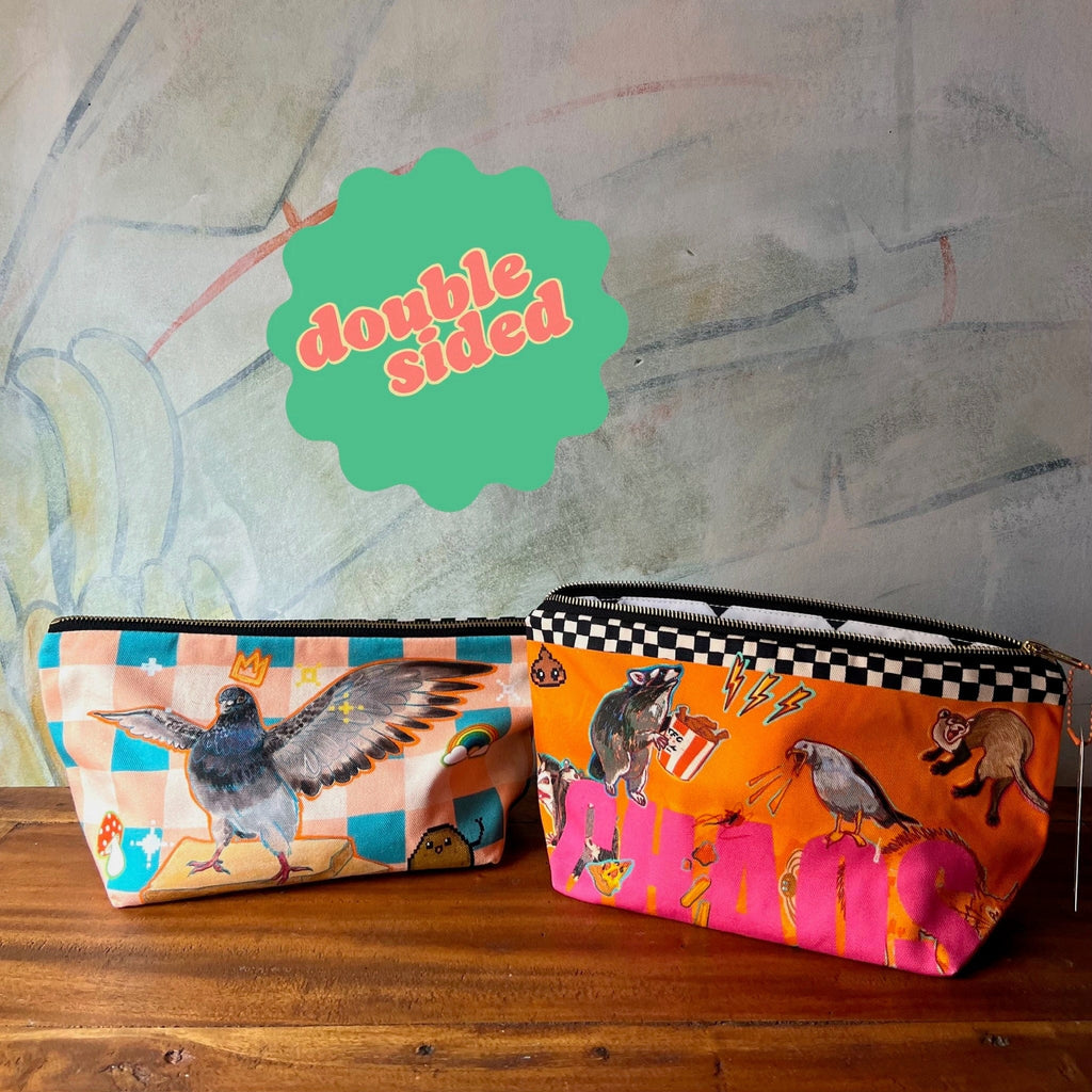 The Chaos Creatures Pouch by Aventures Des Créatures features two zippered sides with unique bird and animal illustrations, plus a green "double sided" label. Handmade in the UK, it's perfect for stylishly storing your essentials.