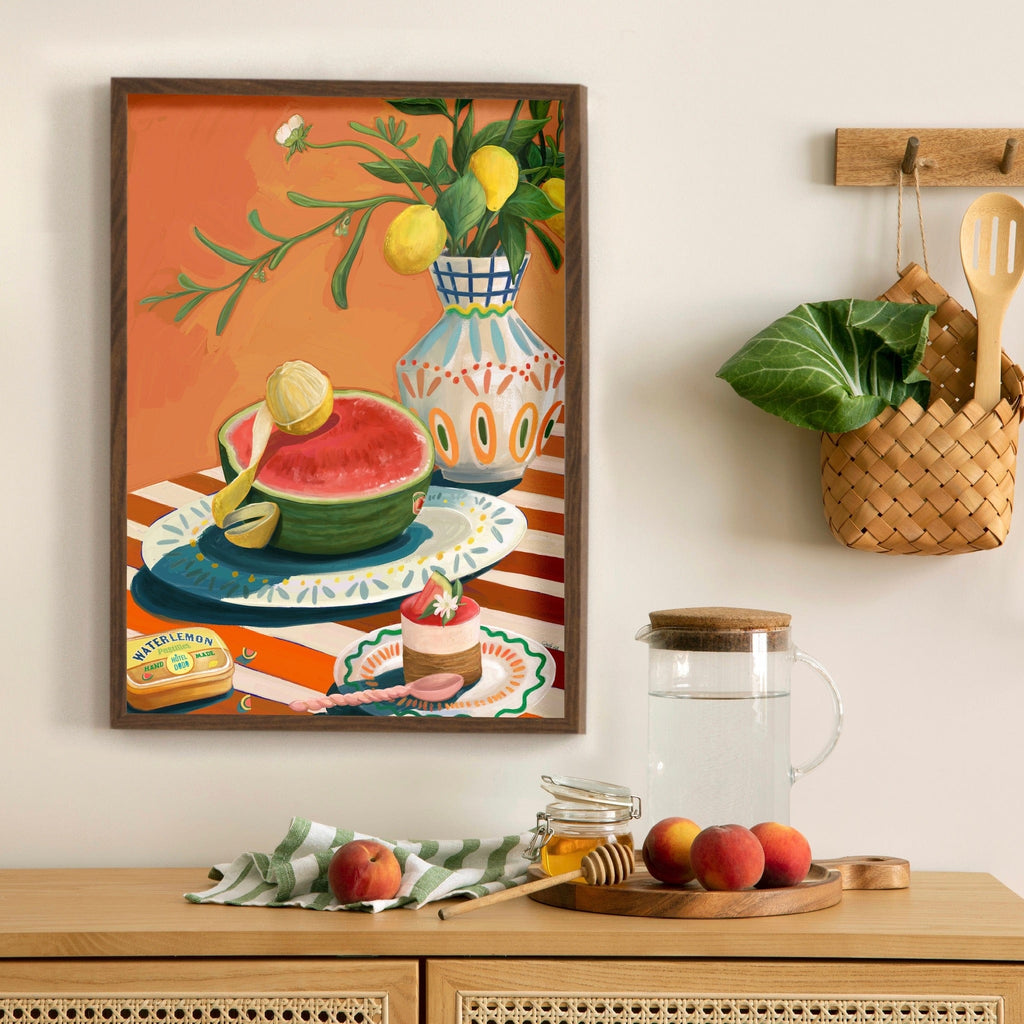 The Hôtel Dodo Watermelon Giclée Art Print from Hôtel Dodo depicts watermelon and lemons above a counter with fresh fruit, a honey dipper, and a woven basket—perfect Mediterranean snack inspiration.