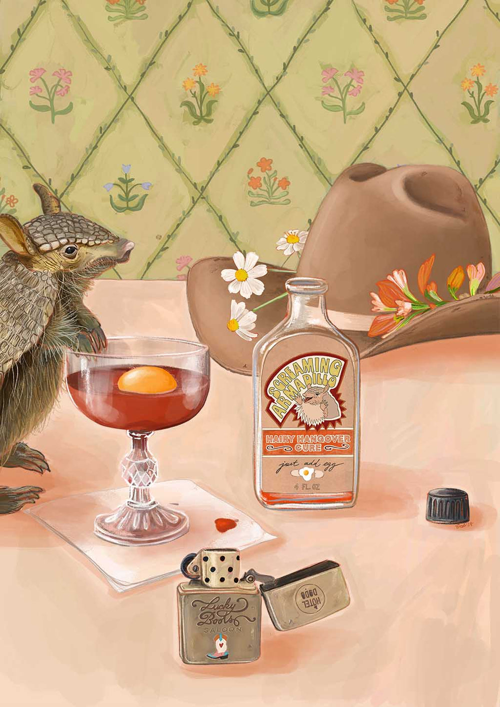 An armadillo rests next to a Prairie Oyster Giclée Art Print from Hôtel Dodo, accompanied by a whiskey bottle, a hat, and an open lighter on a table with a floral backdrop. This quirky arrangement could be the ultimate hangover cure at Hôtel Dodo.