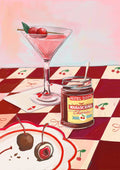 A Cherry Bomb Giclée Art Print by Hôtel Dodo features a martini glass filled with cherry delights on a napkin next to a jar marked "Maraschino Cherries," all displayed against a red checkered tablecloth.